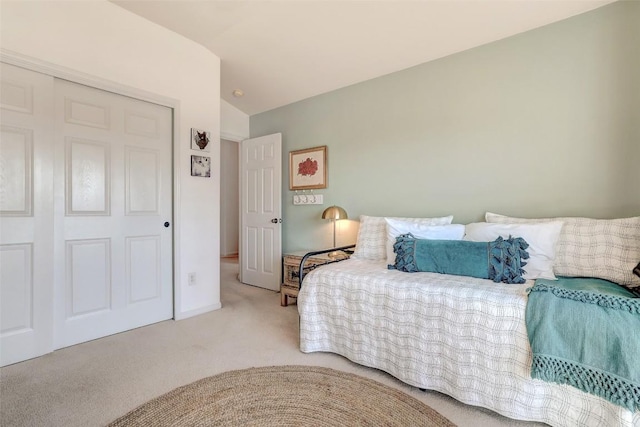 bedroom with vaulted ceiling and light colored carpet