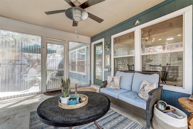 sunroom / solarium with a ceiling fan