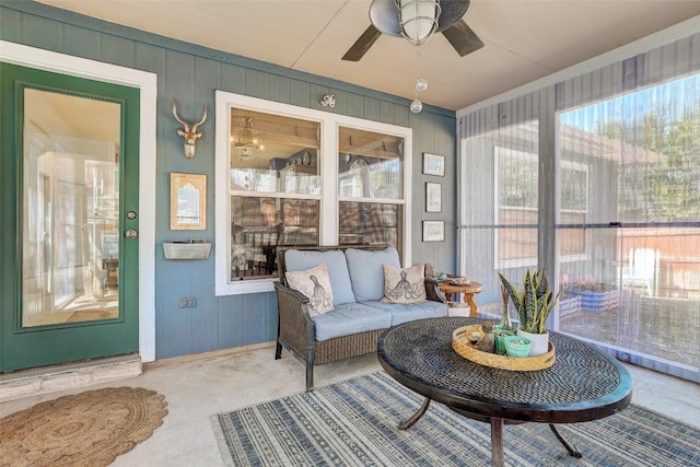 sunroom / solarium with a ceiling fan