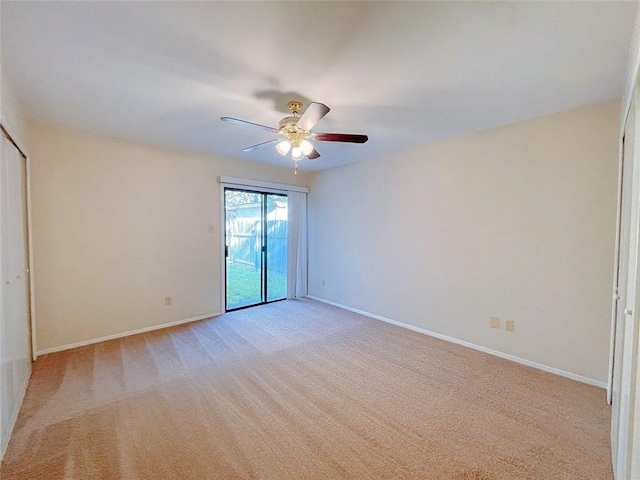 unfurnished room with light carpet, baseboards, and a ceiling fan