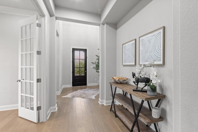 entrance foyer featuring light wood-type flooring and baseboards