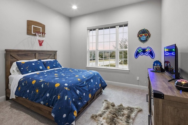 carpeted bedroom featuring baseboards and recessed lighting