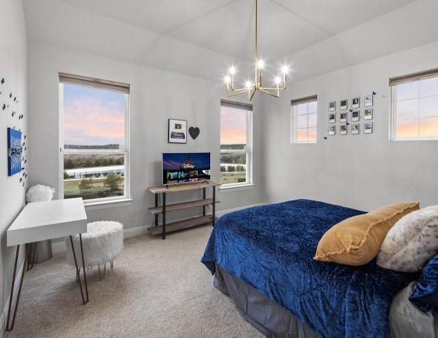 bedroom with carpet floors, baseboards, a notable chandelier, and lofted ceiling