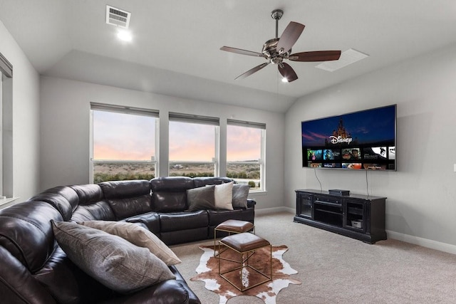 living area with lofted ceiling, carpet floors, a ceiling fan, visible vents, and baseboards