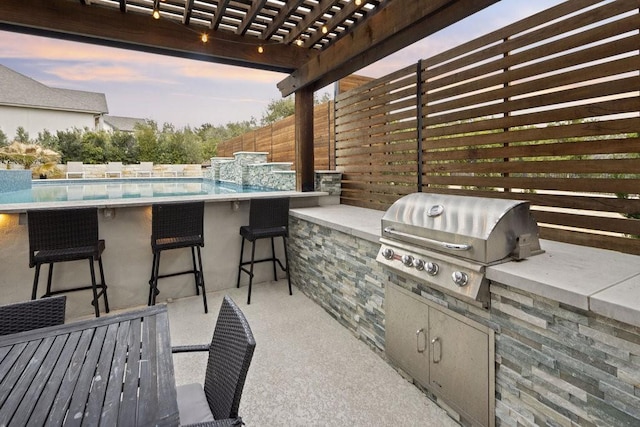 view of patio with grilling area, area for grilling, fence, a pergola, and an outdoor bar