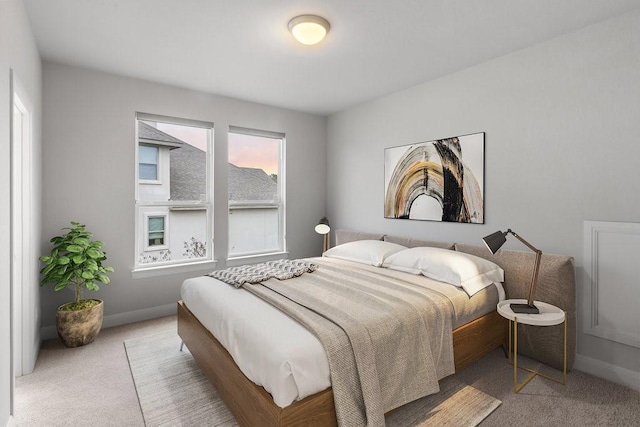 bedroom featuring carpet and baseboards