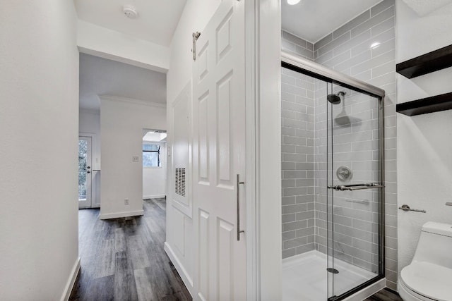 3840 Far W Blvd Unit 215, Austin, TX 78731 - bathroom featuring toilet, a stall shower, wood finished floors, and baseboards