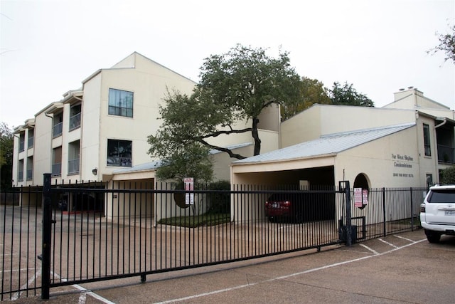 3840 Far W Blvd Unit 215, Austin, TX 78731 - view of building exterior featuring a fenced front yard and uncovered parking