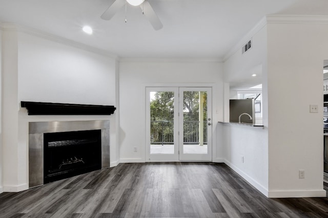 3840 Far W Blvd Unit 215, Austin, TX 78731 - unfurnished living room featuring wood finished floors, ceiling fan, crown molding, a fireplace, and baseboards