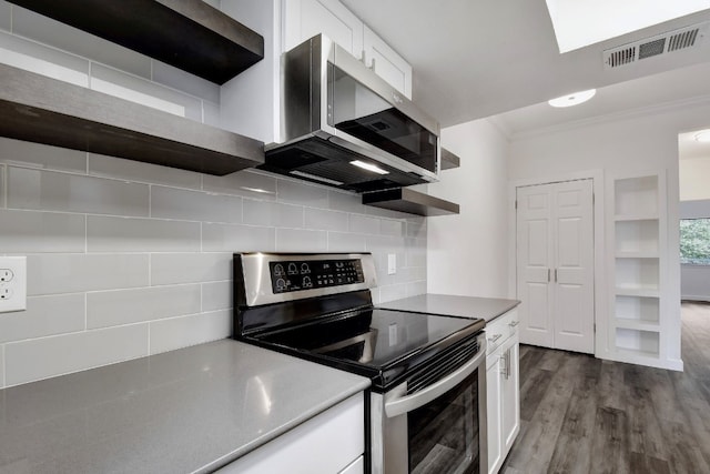 kitchen featuring stainless steel appliances, visible vents, white cabinets, open shelves, and crown molding