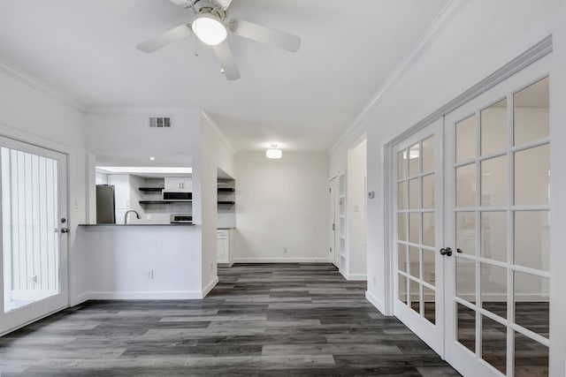 interior space with ornamental molding, freestanding refrigerator, visible vents, and dark wood-type flooring