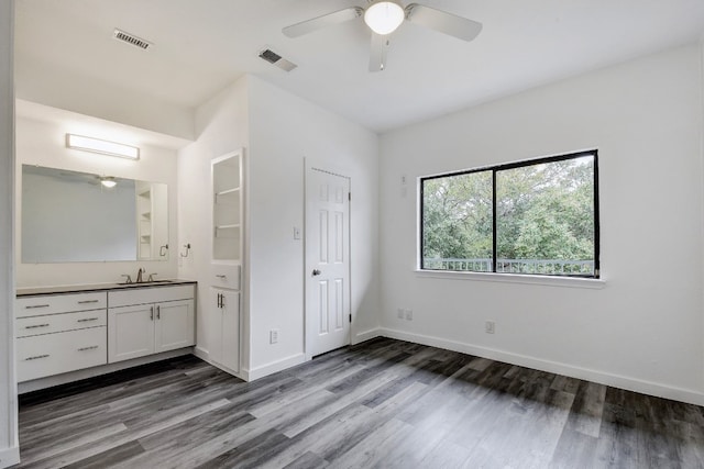 bathroom featuring vanity, wood finished floors, visible vents, and baseboards