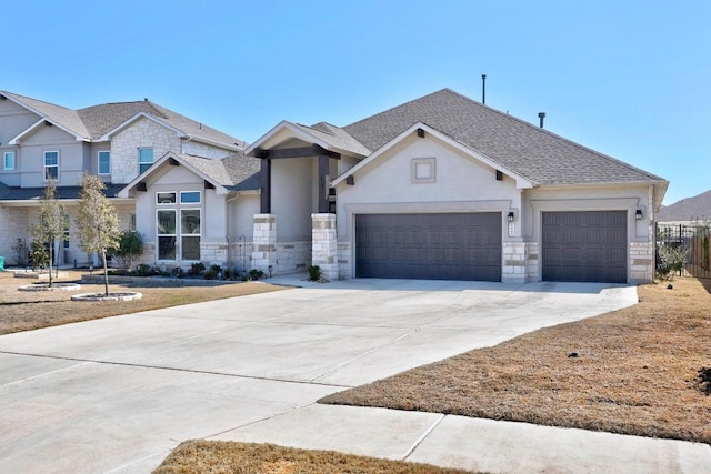 craftsman inspired home featuring a garage, stone siding, a shingled roof, and concrete driveway