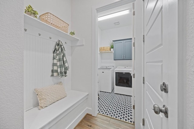 mudroom featuring light wood-style floors and washer and clothes dryer