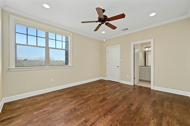 unfurnished bedroom featuring ornamental molding, dark wood-type flooring, and baseboards