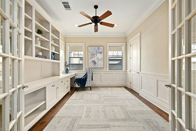 unfurnished office featuring a decorative wall, visible vents, ornamental molding, french doors, and dark wood finished floors