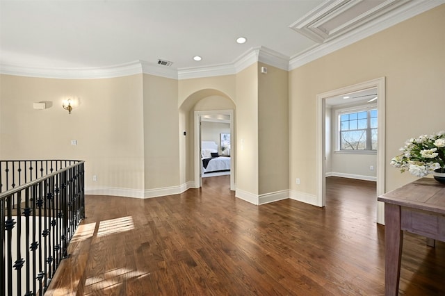 hall with arched walkways, recessed lighting, dark wood-type flooring, ornamental molding, and baseboards