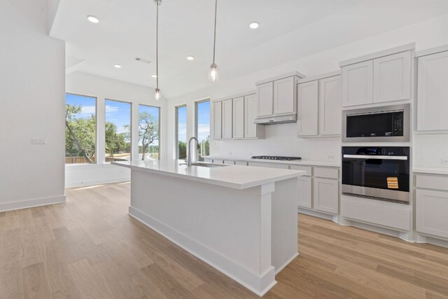100 Wild Bluebell Cv, Georgetown, TX 78628 - kitchen featuring oven, built in microwave, gas stovetop, light countertops, and tasteful backsplash