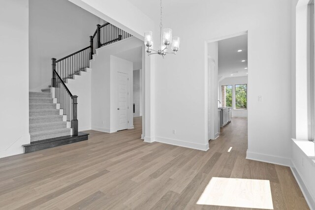 100 Wild Bluebell Cv, Georgetown, TX 78628 - unfurnished dining area with stairs, light wood-type flooring, a chandelier, and recessed lighting