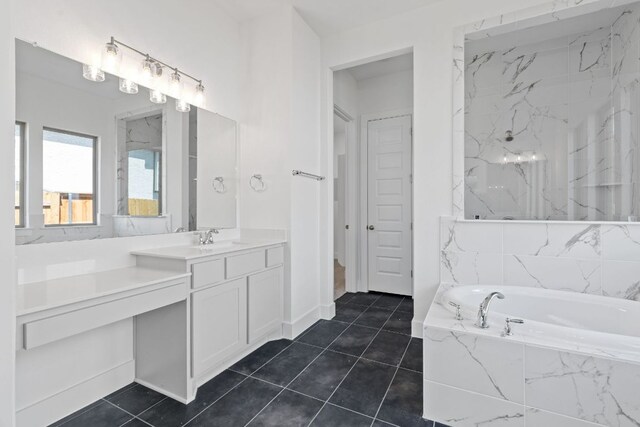 100 Wild Bluebell Cv, Georgetown, TX 78628 - bathroom featuring a garden tub, vanity, and tile patterned floors