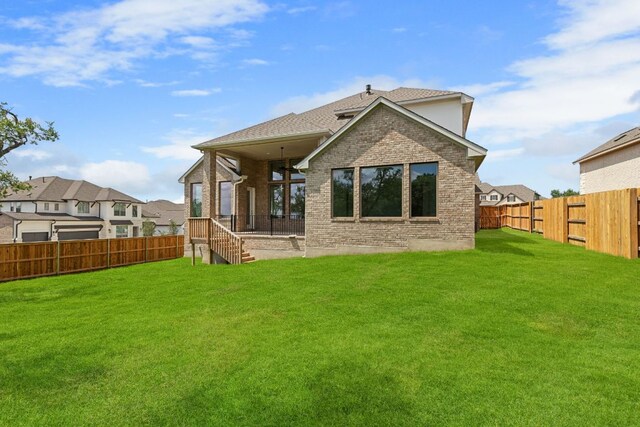 100 Wild Bluebell Cv, Georgetown, TX 78628 - back of house with a fenced backyard and brick siding