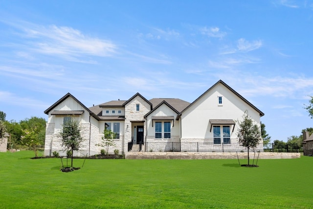 view of front of home with stone siding and a front lawn