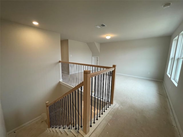 hall featuring visible vents, recessed lighting, an upstairs landing, and baseboards