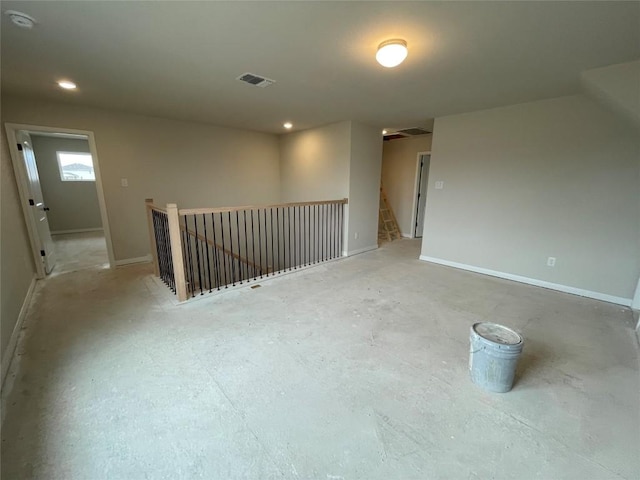 spare room with recessed lighting, visible vents, and baseboards