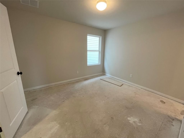 empty room featuring baseboards, visible vents, and unfinished concrete flooring