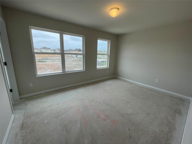 empty room featuring baseboards