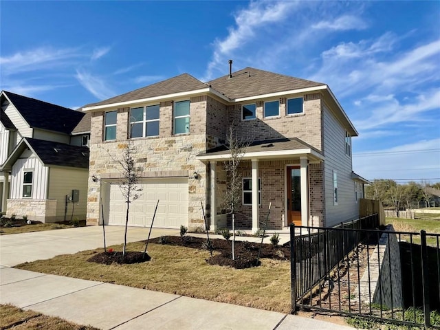 traditional-style home with a garage, brick siding, fence, concrete driveway, and stone siding