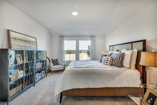 carpeted bedroom featuring lofted ceiling