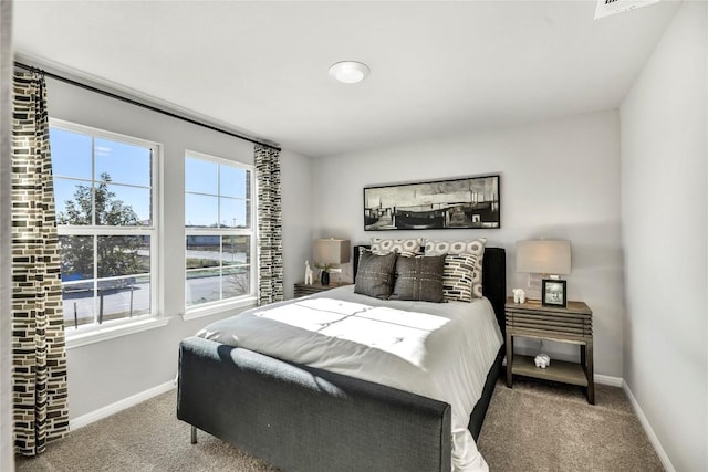 bedroom featuring carpet and baseboards