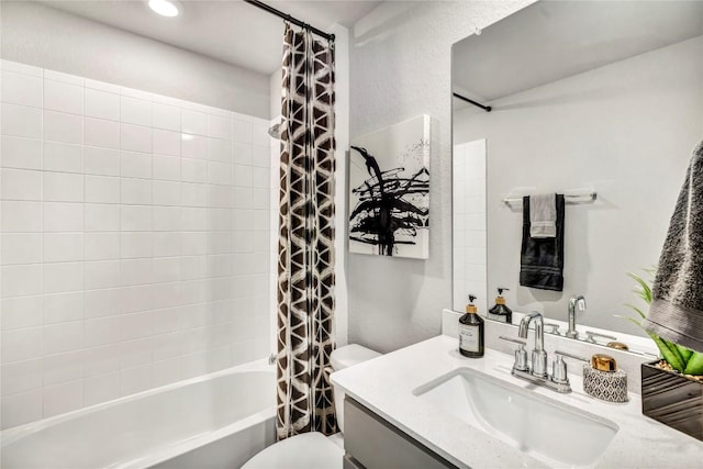 bathroom featuring toilet, shower / tub combo, and vanity