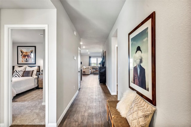 hallway with baseboards and dark wood finished floors