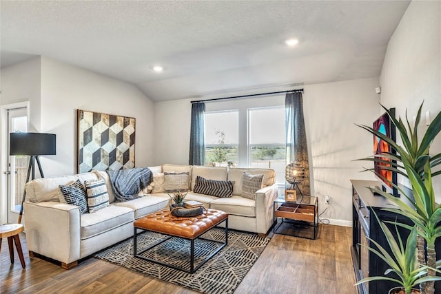 living area with recessed lighting, vaulted ceiling, a textured ceiling, wood finished floors, and baseboards