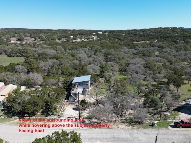 drone / aerial view featuring a forest view