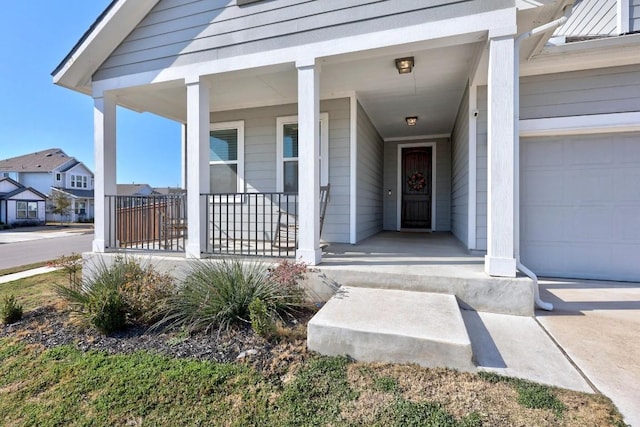 view of exterior entry featuring a porch