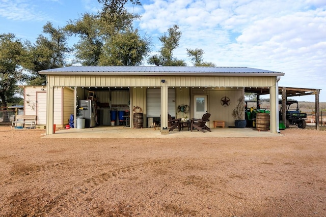 exterior space with metal roof, a carport, and board and batten siding