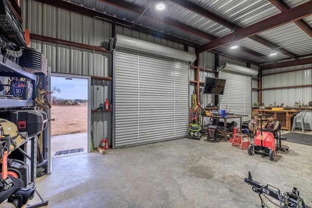 garage featuring a workshop area and metal wall