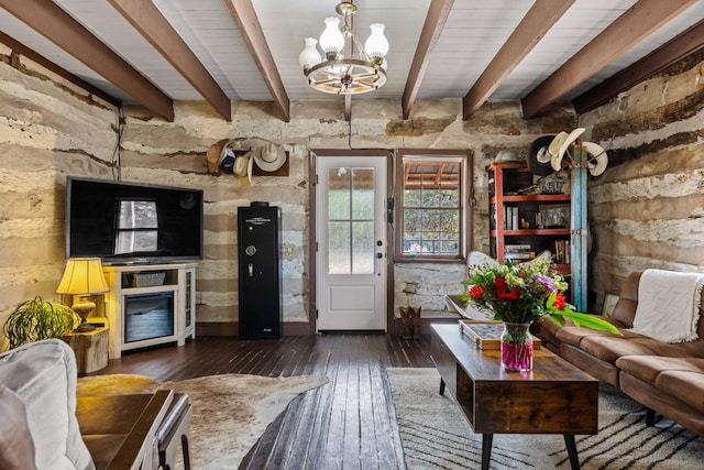 living room with dark wood-style floors, beam ceiling, and an inviting chandelier