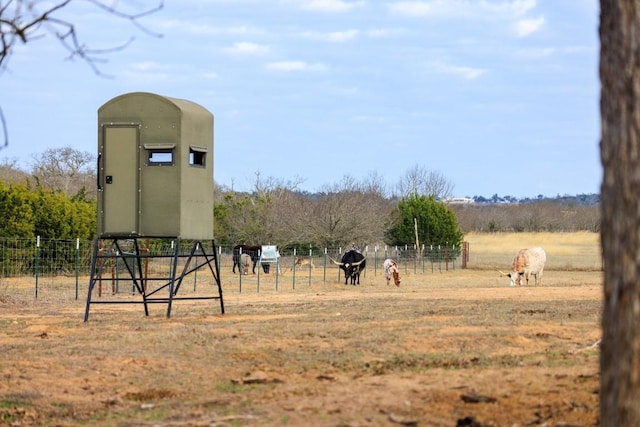 exterior space featuring a rural view and fence