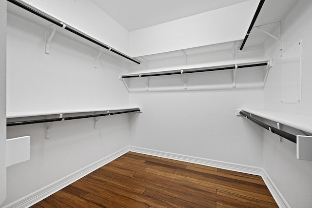 walk in closet with wood finished floors