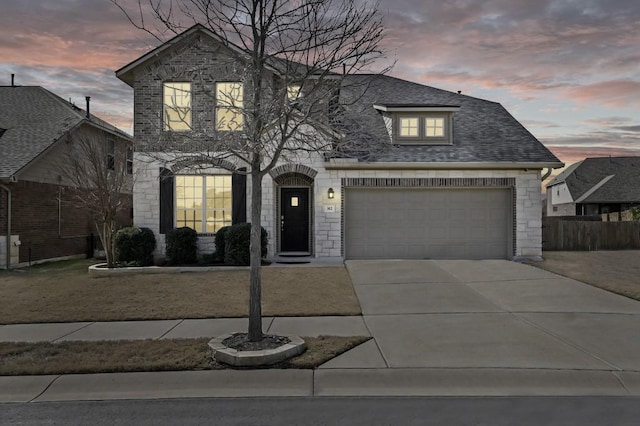 view of front of house featuring a garage, stone siding, concrete driveway, and roof with shingles