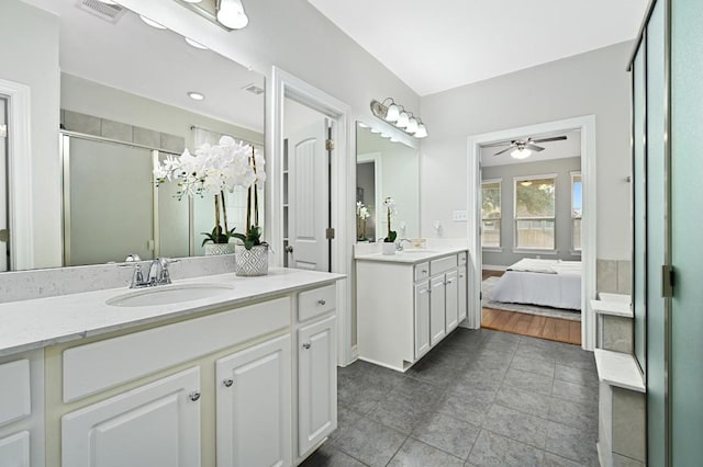 ensuite bathroom with ensuite bathroom, a stall shower, a sink, and visible vents