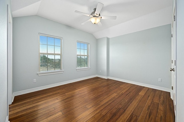 unfurnished room with lofted ceiling, dark wood-type flooring, and baseboards