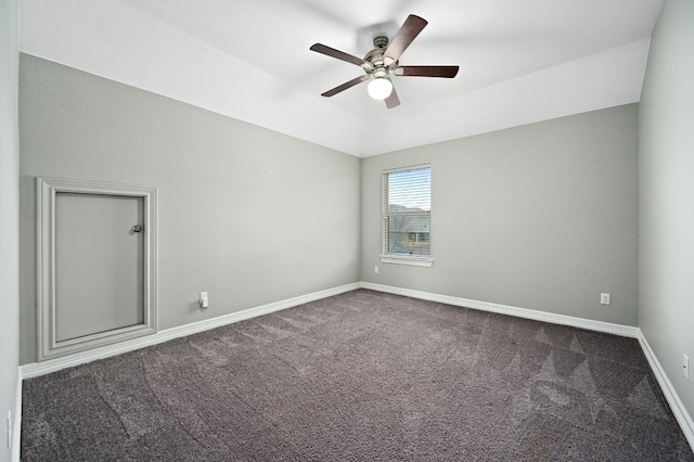 carpeted empty room with lofted ceiling, baseboards, and a ceiling fan