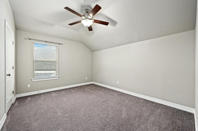 bonus room featuring lofted ceiling, a textured ceiling, a ceiling fan, baseboards, and carpet