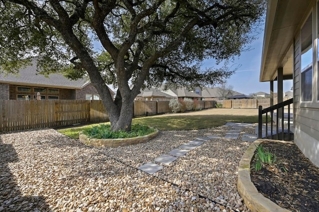 view of yard with a residential view and a fenced backyard