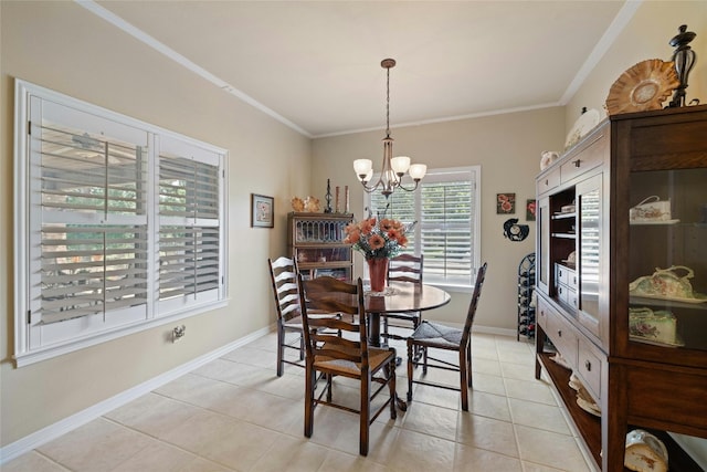 dining area with light tile patterned floors, baseboards, ornamental molding, and a notable chandelier